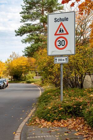 German traffic sign speedlimit 30 and caution schoolの写真素材