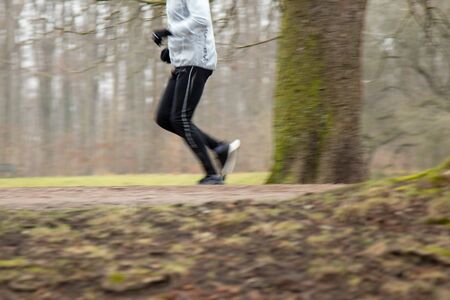 man is jogging in the park autumnの写真素材