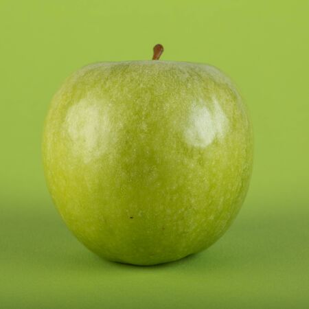 green apple with green backgroundの写真素材