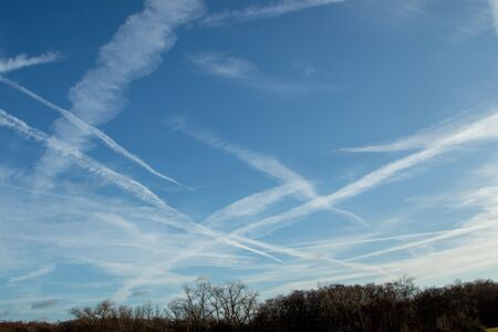 Contrails of airplanes in the blue sky, day