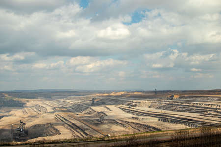 view into the brown cole opencast mine Hambach, several diggers are working in the mineのeditorial素材