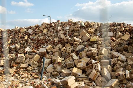stones and other material on a mound after demoplition work on a house, blue sky