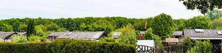 view into a allotment gardens, hedges left and right, roof of tiny houses, springの写真素材