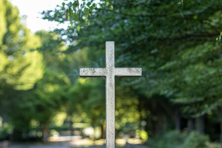 metal cross at the entrance of a cemetery, bokehの写真素材