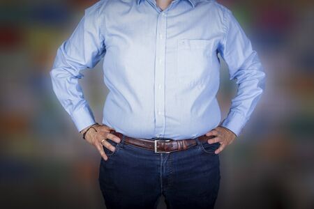 man with a big belly wearing  a shirt and jeans, front viewの写真素材