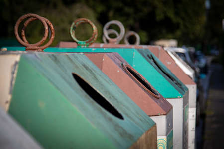 glass container for green glass, amber glass and white glass, focus on the front container, old glass, old glass container, outdoorsの写真素材