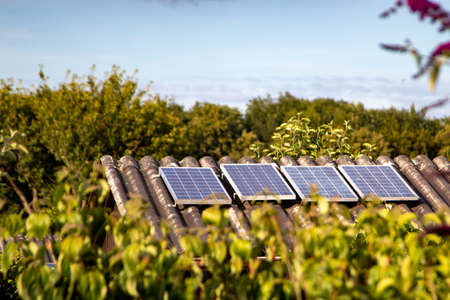 solar panels on a small house roof, allotment gardenの写真素材