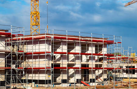 construction cranes at house construction side, outdoorsの写真素材