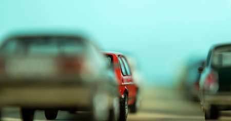 Looking through two rows of toy cars, symbol for start traffic and traffic jam, focus on one car,...