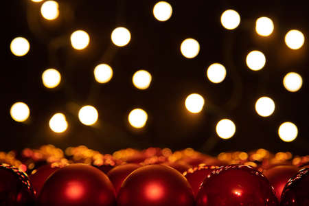 large group of red christmas balls and bokeh light int he black background, card motiveの写真素材