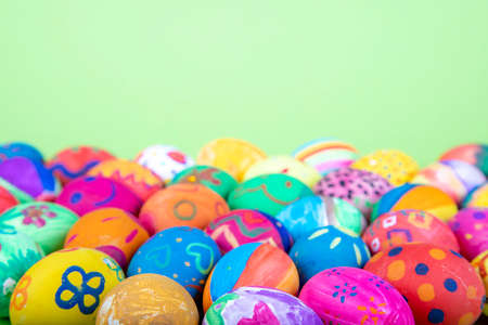 painted eggs before green background, easter motifsの写真素材