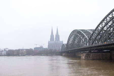 panorama of Cologne with cathedral and hohenzollern bridge at snowy weather. rhine river with high waterの写真素材