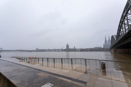 panorama of Cologne with cathedral and hohenzollern bridge at snowy weather. rhine river with high waterの写真素材
