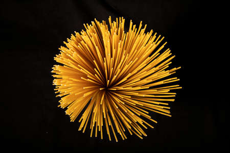 close-up of spaghetti pasta, shot from above, black background