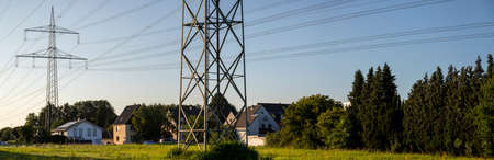 Huerth, NRW, Germany, 08 14 2021, power pylon with power wires nearby housesのeditorial素材