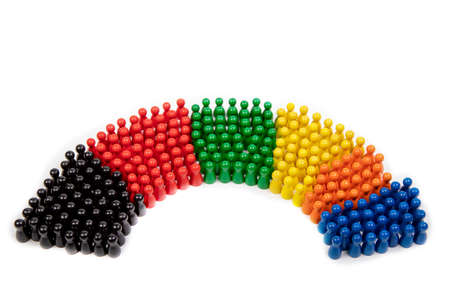 wooden figurines in the colors of German political parties and the rotunda of the German parliamentの写真素材
