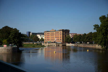 Hameln, Lower Saxony, Germany, 09 03 2021, town library of Hameln, reflection in Weser river, blue...