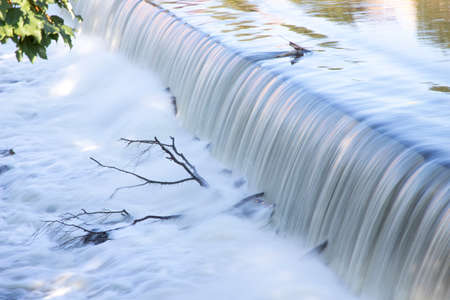man-made waterfall on a riverの写真素材