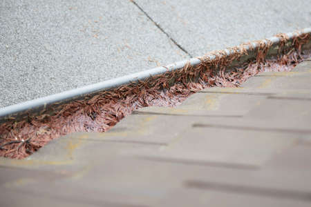 dirty gutter on an old house roofの写真素材