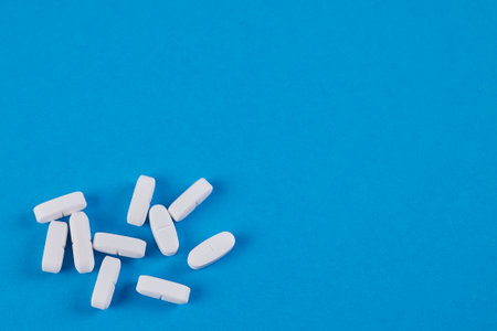 blue background with white pills in bottom left corner, space for text