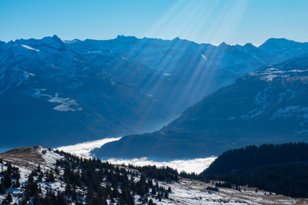 Swiss Alps high above Walensee: a valley full of fog and mountains in the sunの写真素材