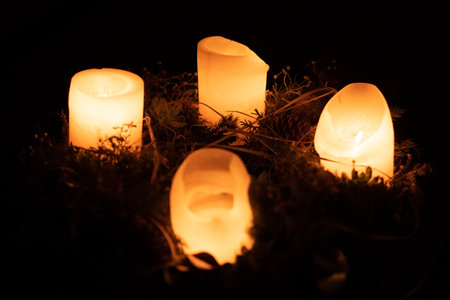 Burning candles on an advent wreast in the darkの写真素材