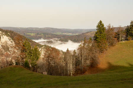 View from hiking trail to Chasseral into a valley filled with fog