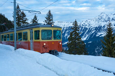 A train of the historic railway arrives at Muerren, a village in Switzerlandの写真素材