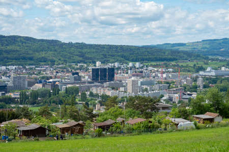 View over the green meadows of Limmattal. Switzerland, towards the urban valleyの写真素材