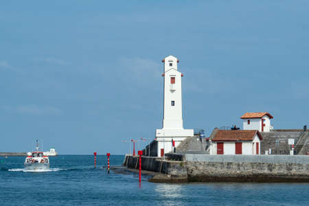 Saint-Jean-de-Luz, France - September 4th 2018: A boat is entering the harbourのeditorial素材
