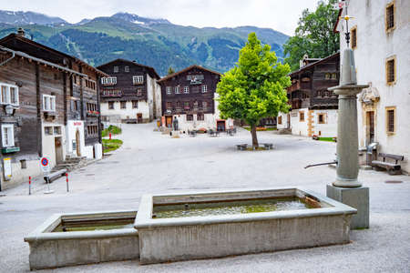 Ernen, Switzerland - June 15th 2020: Village square with buildings and fountainのeditorial素材