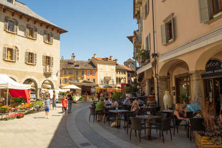 Domodossola, Italy - June 30th 2021: Lively main square on a market day in the historic city centre