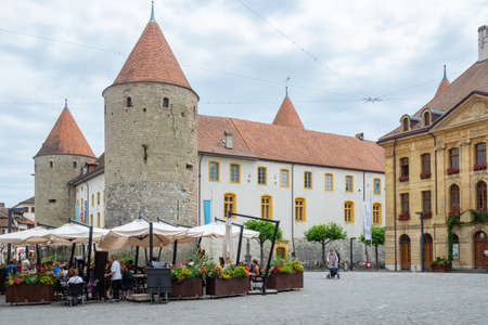 Yverdons-les-bains, Switzerland - July 11th 2021: Historic facades, a restaurant and the tower in the city centreのeditorial素材