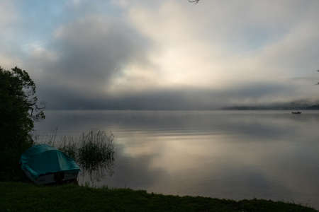 An early morning at Lac de Joux, Switzerland: Beautiful scenery with fog and the rising sunの写真素材