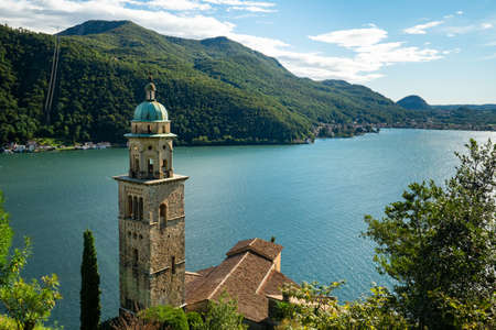 Morcote, Switzerland - October 6th 2021: View over the historic church to Lago di Luganoの写真素材