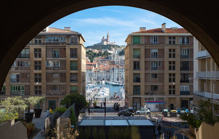 Marseille, France - May 15th 2022: View between housing blocks towards the harbour and church Notre-Dame-de-la-Gardeのeditorial素材