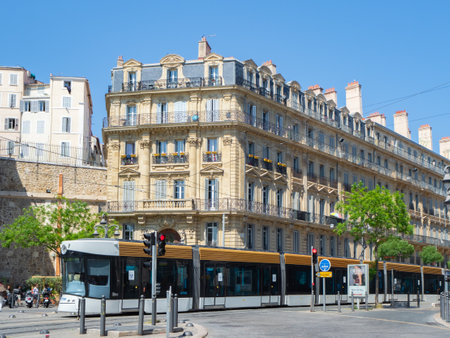 Marseille, France - May 15th 2022: A modern tram car in front of historic housing blocksのeditorial素材