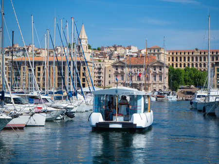 Marseille, France - May 15th 2022: Small solar powered pedestrian ferry crossing old harbourのeditorial素材