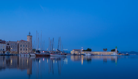 La Ciotat, France - May 17th 2022: Sailing yachts in front of the historic centre during blue hourのeditorial素材