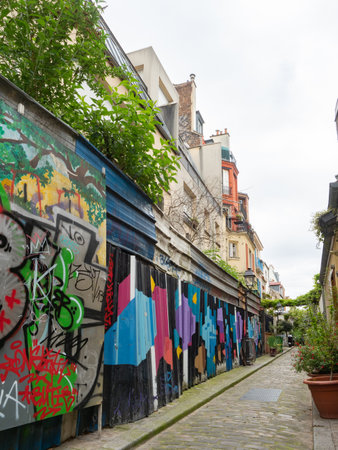 Paris, France - May 11th 2023: The famous alleyway of Rue des Tulipes with plant troughs and street art.のeditorial素材