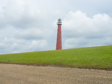 Den Helder, Netherlands - August 6th 2023: The historic lighthouse situated directly behind the damのeditorial素材