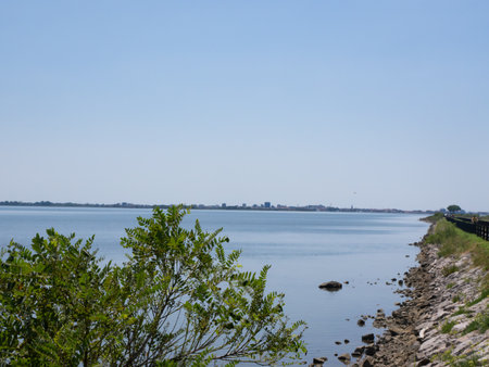 Grado, Italy - July 30th 2024: Dam towards the touristic village of Grado behind the lagoons and islandsの写真素材
