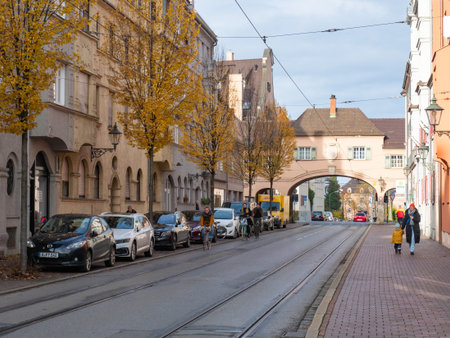 Augsburg, Germany - November 18th 2023: View along historic facades towards Fischertor, border of the old town.のeditorial素材