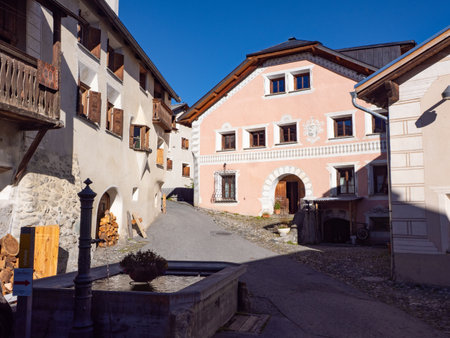 Scuol, Switzerland - October 11th 2025: Historic and authentic village centre of Ftan with a fountain.のeditorial素材
