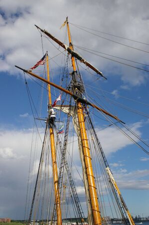 A ships mast reaching high into the sky.