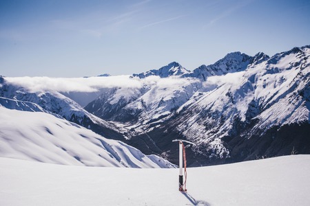 Climbing avalanche peak with ice axe.  Arthurs Pass, Southern Alps, Canterbury, New Zealandの写真素材
