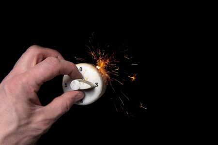 Human hand turning switch at full power causing overloadの写真素材