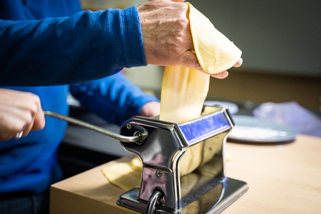 Making handmade italian pasta Ravioli and Tagliatelle for Christmasの写真素材