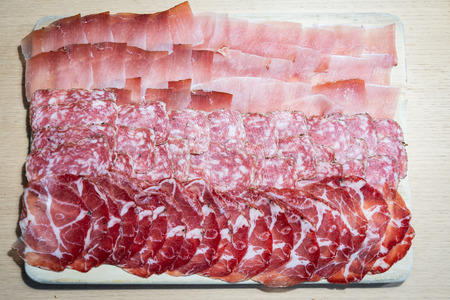 Homemade salami, speck and hamの写真素材
