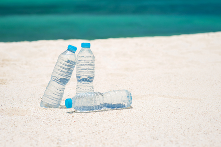 Bottled water on a hot day at the sandの写真素材
